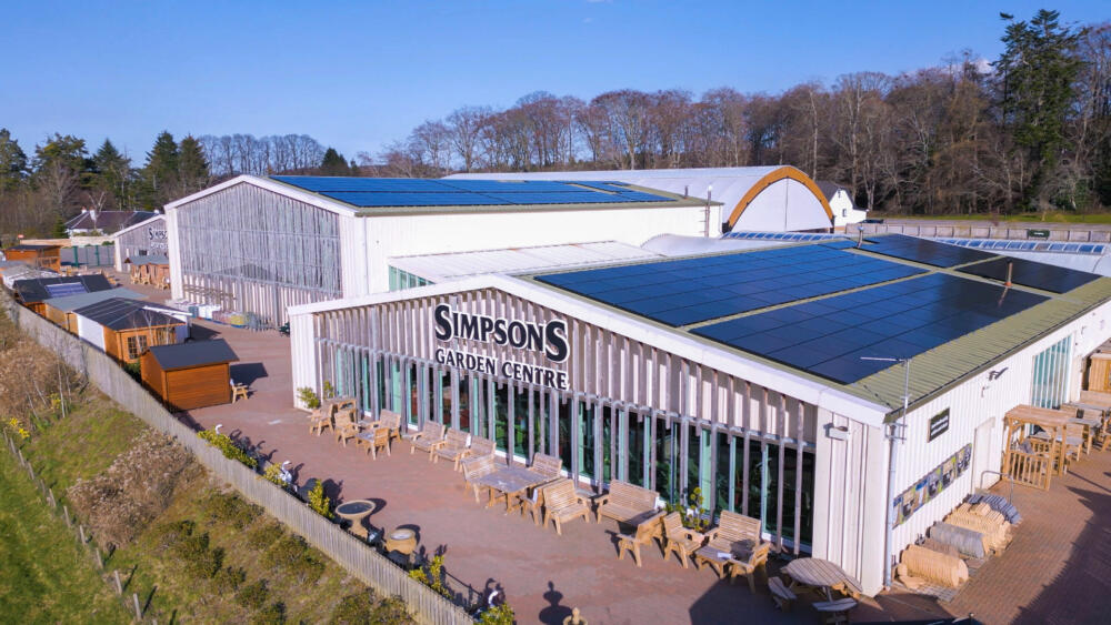 A large solar PV system installed on a garden centre across two different buildings